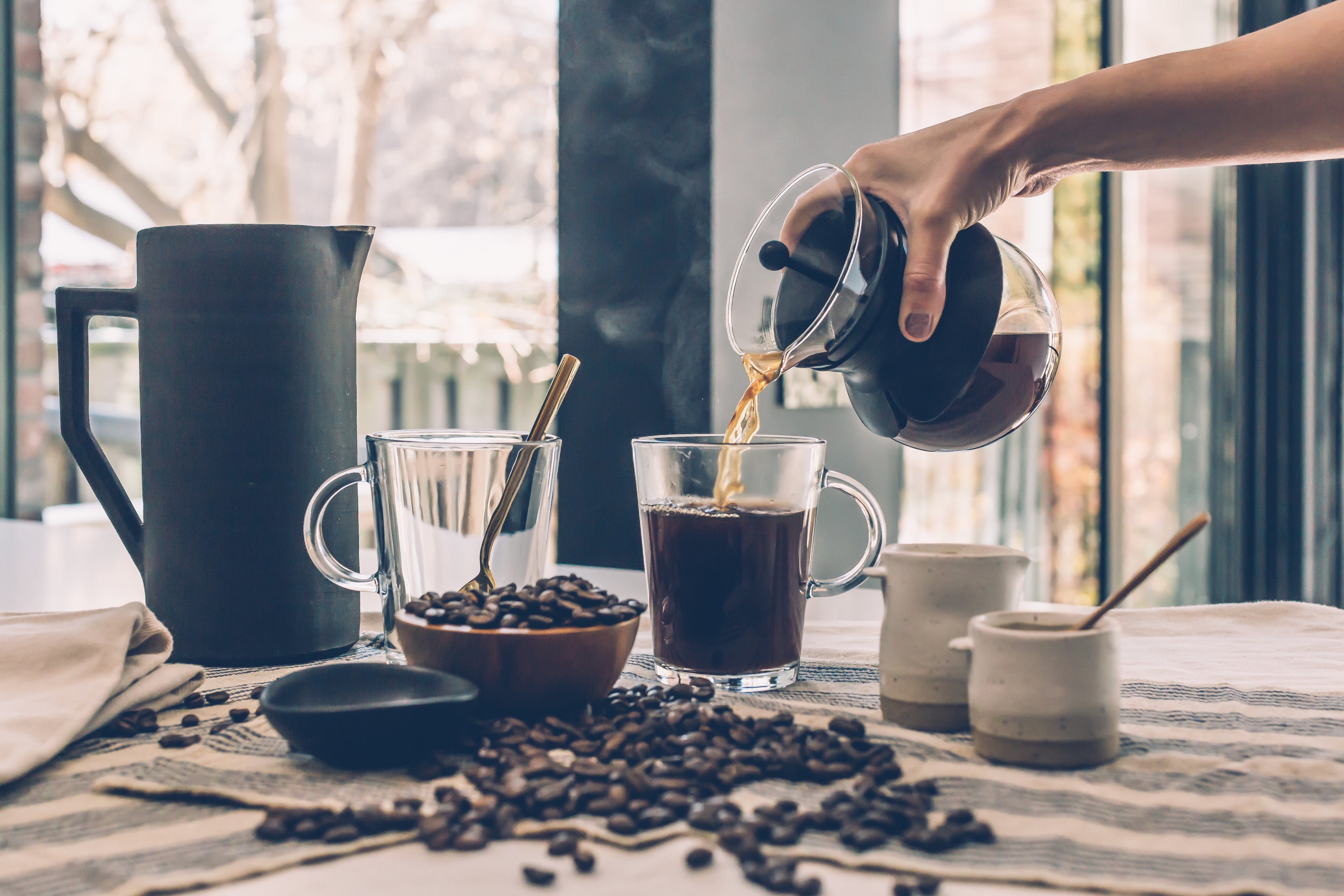 an arm pouring coffee 